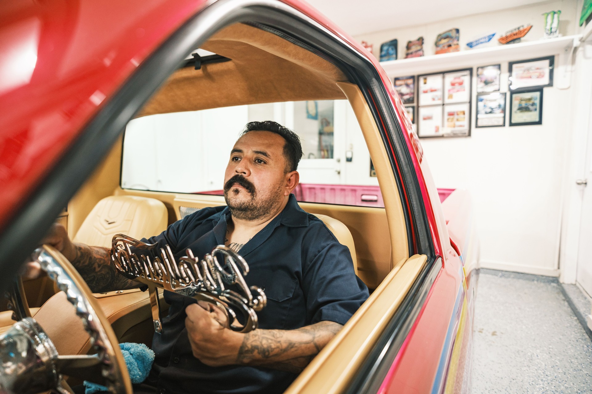 Mexican American man proudly displays his Low Rider Truck